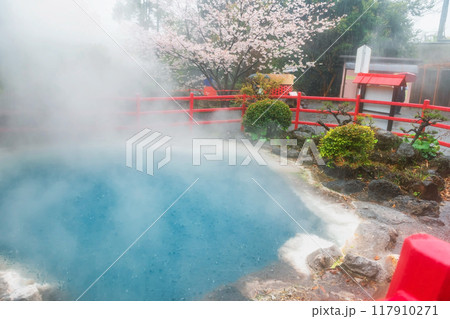 Kamado Jigoku blue hot spring with rain, steam and sakura, Beppu Kamado Jigoku blue hot spring with rain, steam and sakura, Beppu 117910271