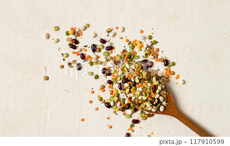 wooden spoon, with an assortment of legumes, beans, peas, top view, on a light background, wooden spoon, with an assortment of legumes, beans, peas, top view, on a light background, 117910599