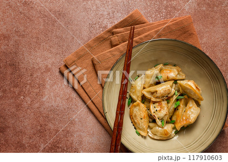 japanese fried gyoza dumplings, with pork, sesame seeds, green onions, 117910603