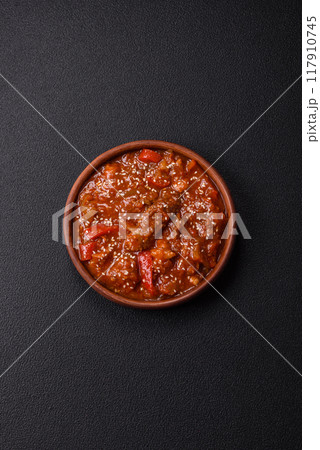 Thai Asian dish with meat, hot pepper, tomato sauce and sesame Thai Asian dish with meat, hot pepper, tomato sauce and sesame 117910745