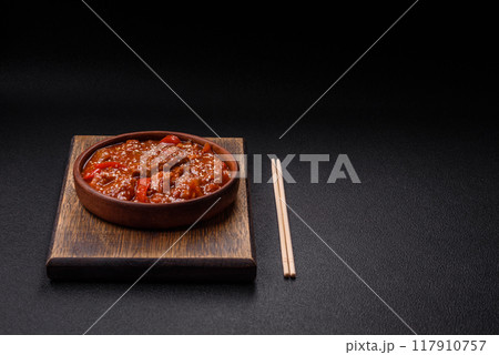 Thai Asian dish with meat, hot pepper, tomato sauce and sesame Thai Asian dish with meat, hot pepper, tomato sauce and sesame 117910757