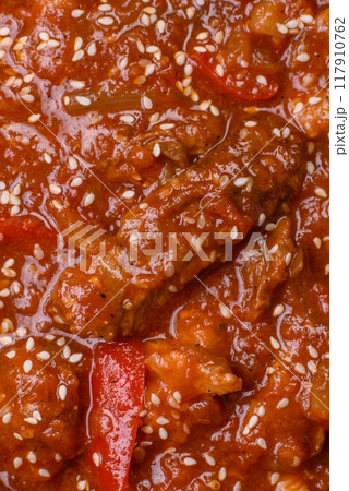 Thai Asian dish with meat, hot pepper, tomato sauce and sesame Thai Asian dish with meat, hot pepper, tomato sauce and sesame 117910762