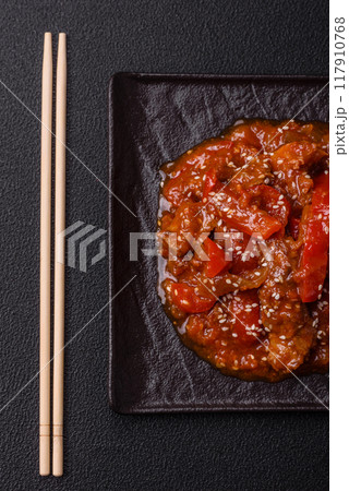 Thai Asian dish with meat, hot pepper, tomato sauce and sesame 117910768
