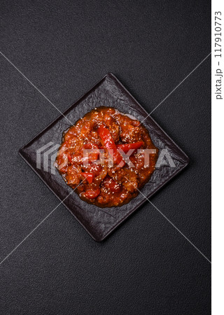 Thai Asian dish with meat, hot pepper, tomato sauce and sesame 117910773