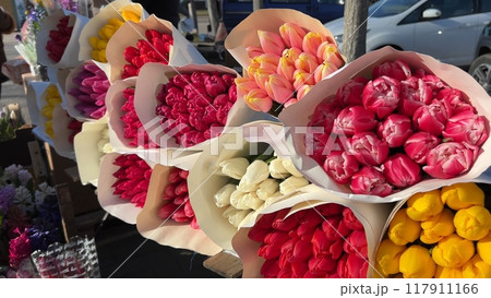 Selling bouquets of tulips on the city street. Selling bouquets of tulips on the city street. 117911166