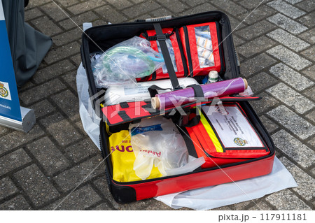 Corby, England, UK - August 31, 2024: Red emergency first aid bag, paramedic fast response in case of life in danger. Doctors kit equipement Corby, England, UK - August 31, 2024: Red emergency first aid bag, paramedic fast response in case of life in danger. Doctors kit equipement 117911181