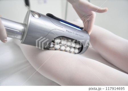 A person receiving a body contouring treatment in a wellness center A person receiving a body contouring treatment in a wellness center 117914695