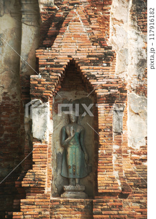 Ancient sandstone sculpture of Buddha at Wat Mahathat ruins is considered a very important temple is Unesco World Heritage Site in Ayutthaya Historical Park in Thailand. 117916182