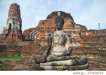 Ancient sandstone sculpture of Buddha at Wat Mahathat ruins is considered a very important temple is Unesco World Heritage Site in Ayutthaya Historical Park in Thailand. 117916253