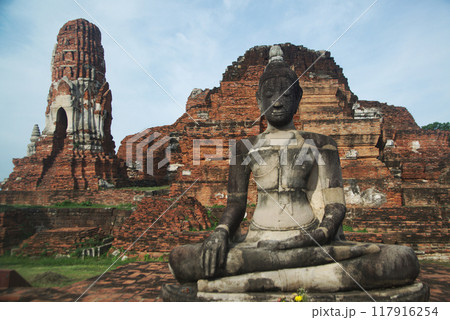 Ancient sandstone sculpture of Buddha at Wat Mahathat ruins is considered a very important temple is Unesco World Heritage Site in Ayutthaya Historical Park in Thailand. 117916254