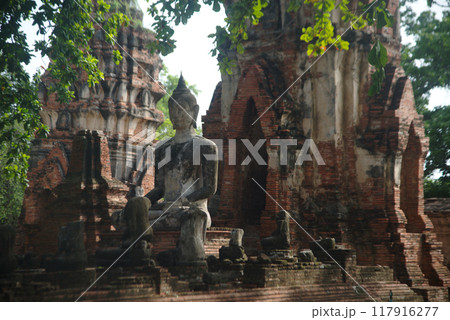 Ancient sandstone sculpture of Buddha at Wat Mahathat ruins is considered a very important temple is Unesco World Heritage Site in Ayutthaya Historical Park in Thailand. 117916277