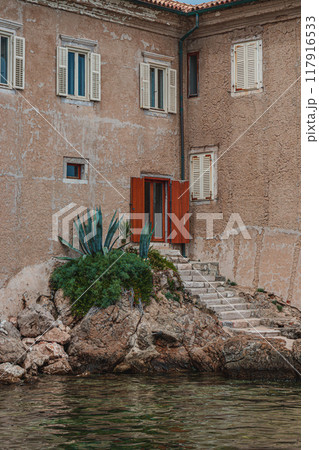 Krk Croatia 26.06.24 Exit from the old poor wall by stairs to the private port Krk Croatia 26.06.24 Exit from the old poor wall by stairs to the private port 117916533