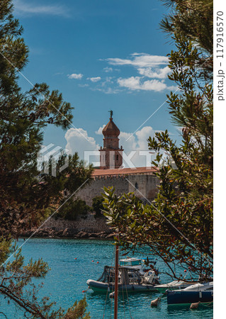 Krk Croatia 26.06.24 Boats on little port beside old town view with vegetation 117916570