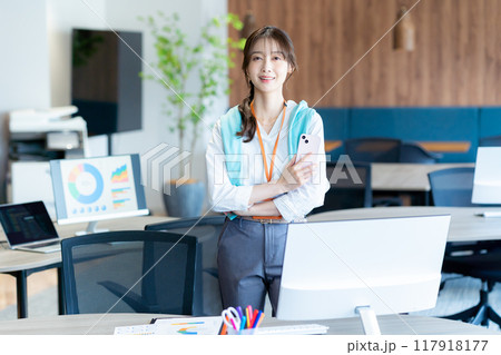 オフィスでスマホを持つビジネスウーマン 117918177