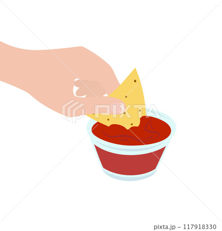 Womans hand with french manicure dipped nachos into glass gravy boat with salsa sauce. Mexican snack 117918330