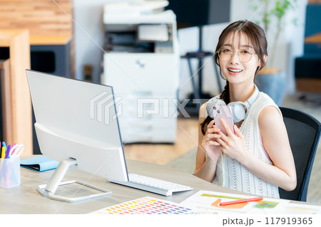 オフィスでスマホを持つビジネスウーマン 117919365