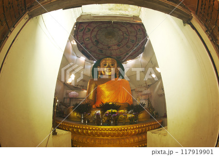 The large main sitting golden buddha in the temple of the Great Vesali image. This is the ancient city of Vesali. the second capital of the Rakhine Kingdom from the 6th-10th Centuries CE. Myanmar. The large main sitting golden buddha in the temple of the Great Vesali image. This is the ancient city of Vesali. the second capital of the Rakhine Kingdom from the 6th-10th Centuries CE. Myanmar. 117919901