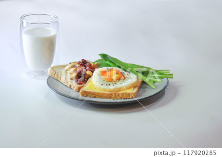 bread with egg and cheese topping or sunny side up egg , lettuce and almond with dried cranberry and milk bread with egg and cheese topping or sunny side up egg , lettuce and almond with dried cranberry and milk 117920285