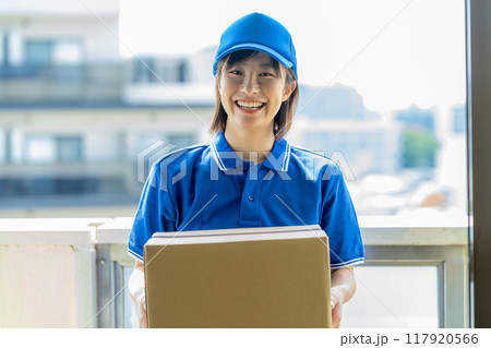 荷物を届ける宅配便の女性ドライバー 荷物を届ける宅配便の女性ドライバー 117920566