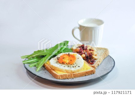 bread with egg and cheese topping or  sunny side up egg , lettuce and almond with dried cranberry and milk 117921171