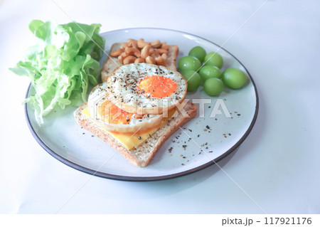 toast or bread with sunny side up egg , cashew nut , grape and lettuce 117921176