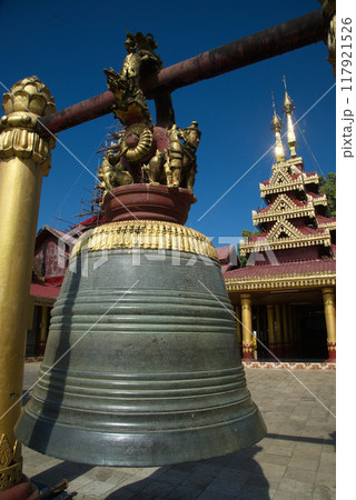 An outdoor large bell hanging front of the chapel or Buddhist church at Wat Mahamuni Phraya temple. It is located on the Rakhine State, Myanmar. An outdoor large bell hanging front of the chapel or Buddhist church at Wat Mahamuni Phraya temple. It is located on the Rakhine State, Myanmar. 117921526