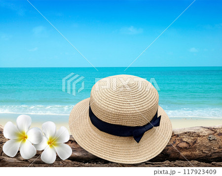 Vintage hat, wooden icon, flowers and tropical sea background. summer paradise cruise travel design tourism, beach, holiday travel destination concept Vintage hat, wooden icon, flowers and tropical sea background. summer paradise cruise travel design tourism, beach, holiday travel destination concept 117923409