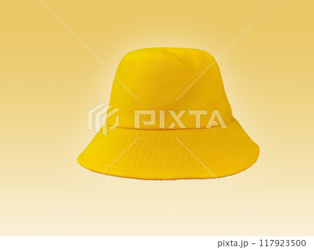 yellow bucket hat isolated on light yellow background 117923500