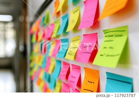 Colorful sticky notes on whiteboard for vibrant brainstorming and creative collaboration 117923787