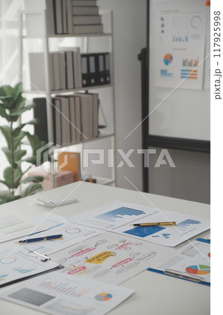 Close up of Business team analyzing income charts and graphs with modern laptop computer. Business analysis and strategy concept. 117925998