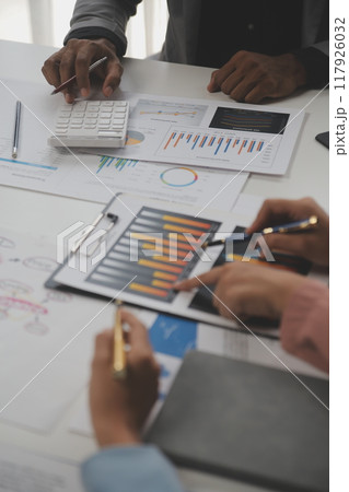 Close up of Business team analyzing income charts and graphs with modern laptop computer. Business analysis and strategy concept. 117926032
