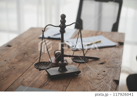 Judge gavel with Justice lawyers having team meeting at law firm background. Concepts of Law and Legal services. 117926041