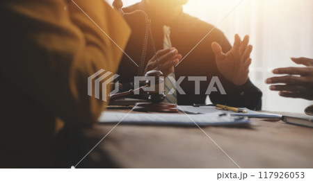 Judge gavel with Justice lawyers having team meeting at law firm background. Concepts of Law and Legal services. 117926053