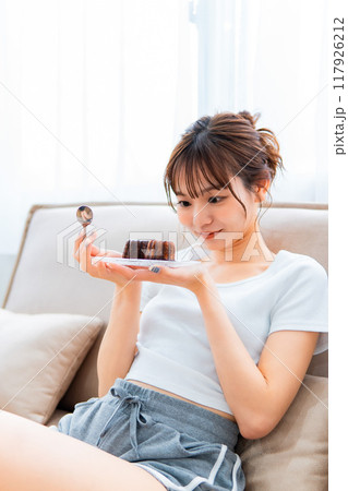 ソファでくつろぐ部屋着の女性/休日の朝/リラックス ソファでくつろぐ部屋着の女性/休日の朝/リラックス 117926212