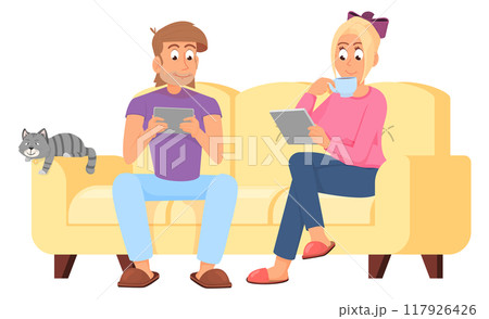 Young man and woman sit on sofa with gadgets at home 117926426
