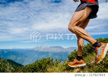 legs runner on steep slope run marathon race in background mountains and sky legs runner on steep slope run marathon race in background mountains and sky 117927853