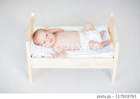 Little baby on toy bed Little baby on toy bed 117928765