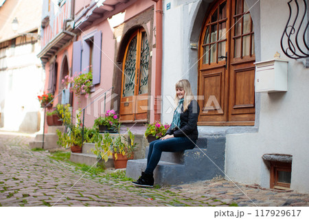 Young woman in historical city center in France 117929617