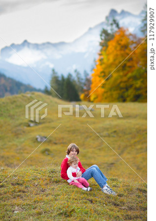 Family with kids hiking in the mountains Family with kids hiking in the mountains 117929907
