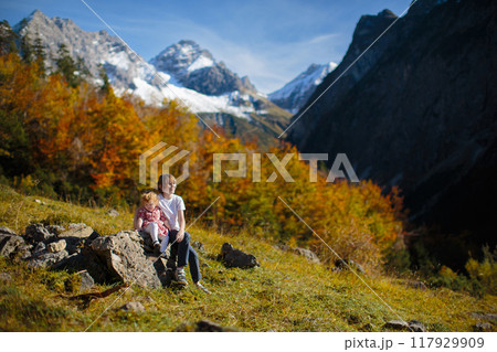 Family with kids hiking in the mountains 117929909