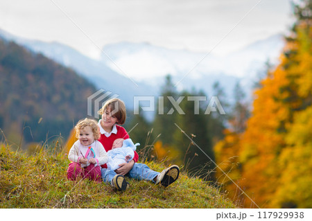 Family with kids hiking in the mountains 117929938