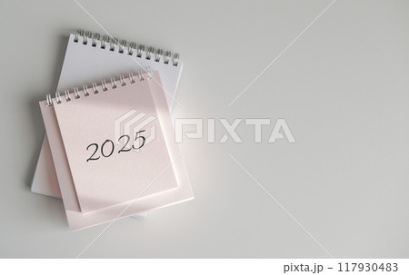 Top view of calendar 2025 on white background 117930483