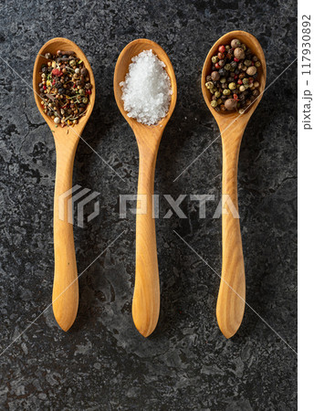 Mix of organic dried spices in wooden spoons. 117930892