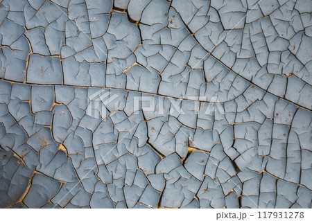 A close-up shot of a weathered surface with peeling blue and orange paint A close-up shot of a weathered surface with peeling blue and orange paint 117931278