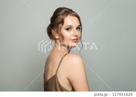 Graceful good-looking woman with updo hairstyle and makeup. Young female model portrait Graceful good-looking woman with updo hairstyle and makeup. Young female model portrait 117931626