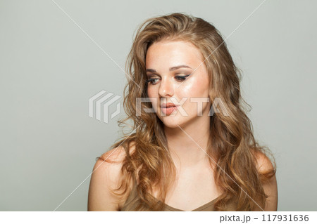 Lady looking aside. Smiling young adult woman studio photo Lady looking aside. Smiling young adult woman studio photo 117931636