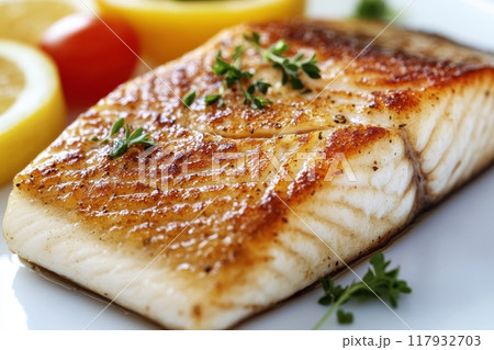A piece of fish is served with parsley and lemon slices with Generative AI 117932703