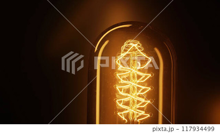 Real classic antique Edison Tungsten filament lamp glowing, vintage retro lightbulb. Creative idea Real classic antique Edison Tungsten filament lamp glowing, vintage retro lightbulb. Creative idea 117934499