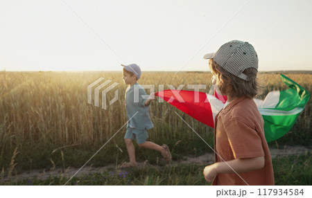 Italian little kids - patriot. football fans children runs with national flag on nature background 117934584
