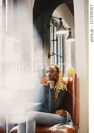 People and leisure concept. Headshot of beautiful African girl. Woman in a gray sweater. 117936367